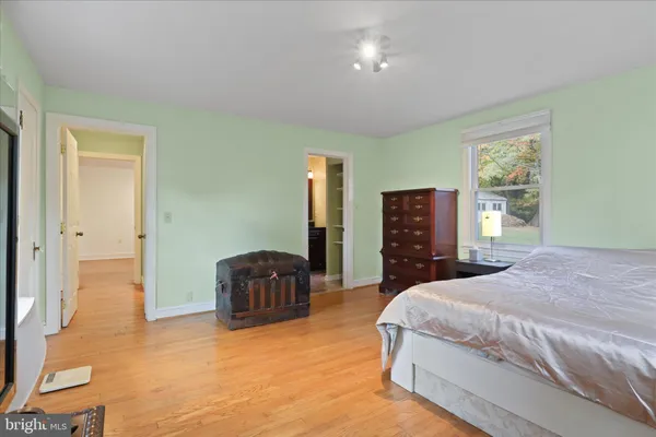 a spacious bedroom with a bed and furniture