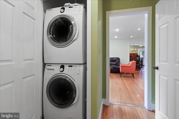 a living room with furniture and a washing machine