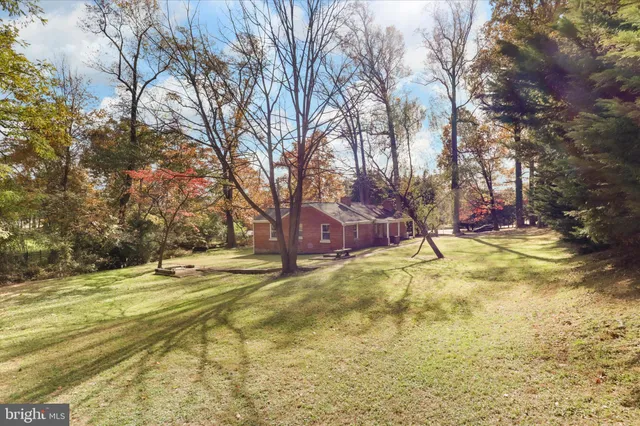 a view of yard with tree and wooden fence