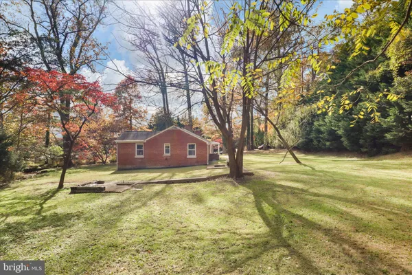 a yellow house in middle of forest