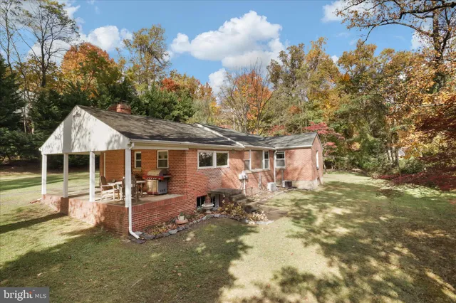 a front view of a house with a yard outdoor seating and garage