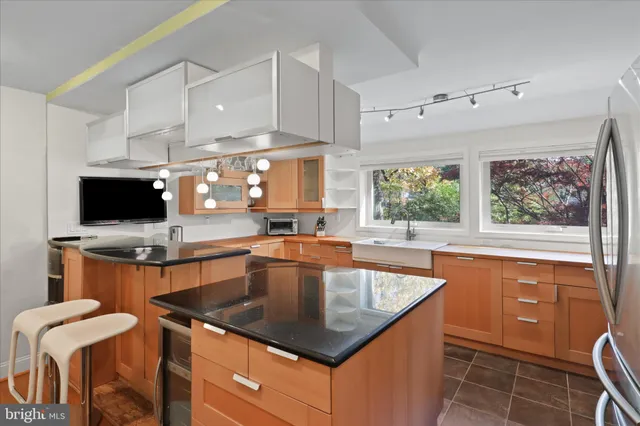 a kitchen with a sink a counter top space and appliances