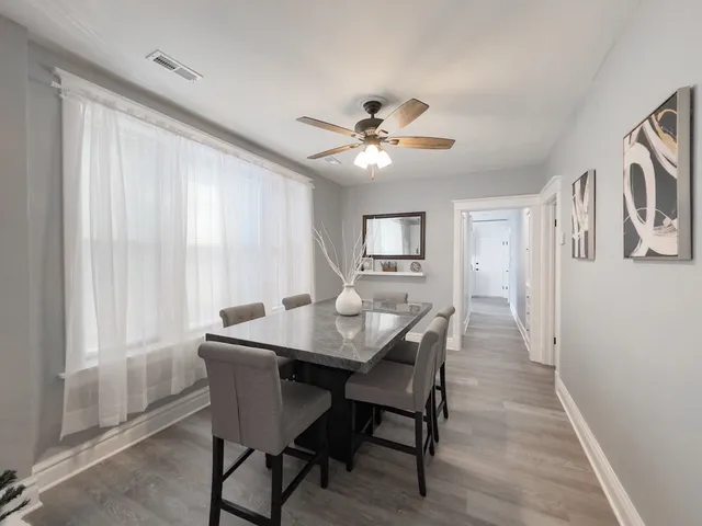 a living room with furniture a rug and a chandelier