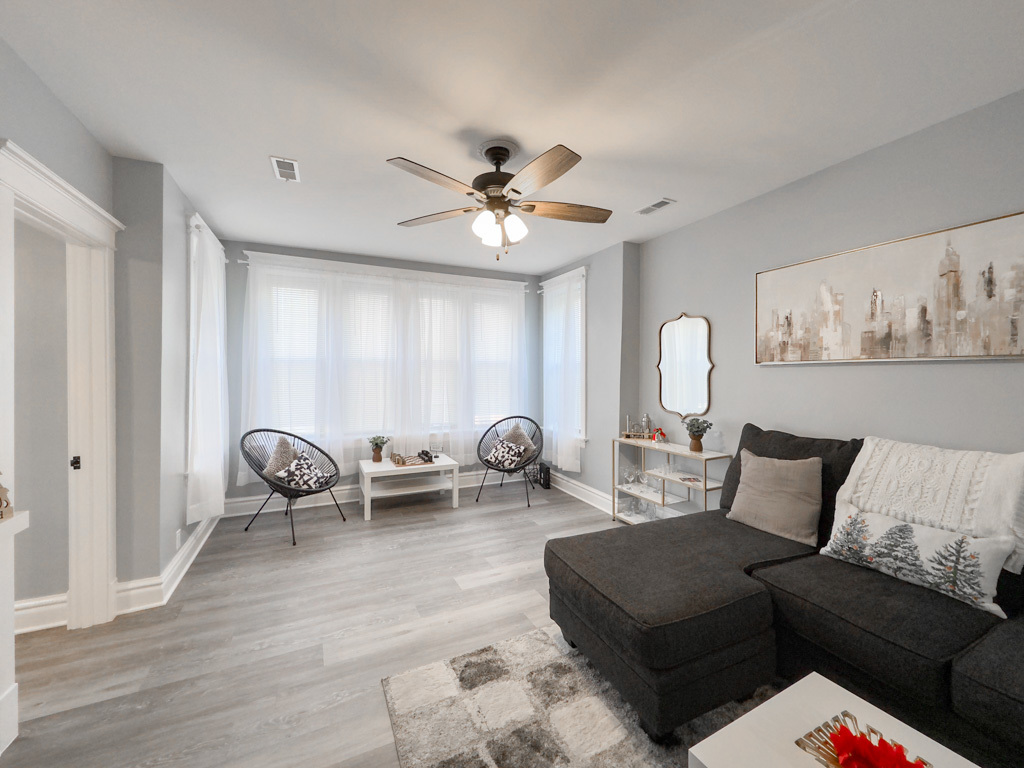 2039 West 23rd Street, Unit 2 Chicago, IL 60608 - Photo 16 of 21 a living room with furniture a rug and a chandelier