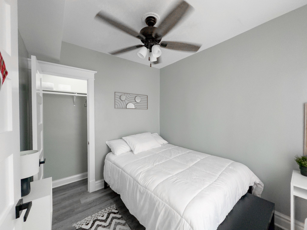 2039 West 23rd Street, Unit 2 Chicago, IL 60608 - Photo 20 of 21 a bedroom with a bed and a chandelier