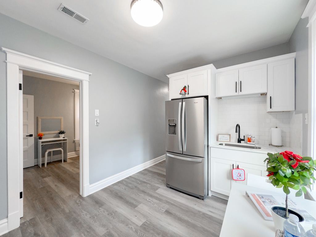 2039 West 23rd Street, Unit 2 Chicago, IL 60608 - Photo 5 of 21 a kitchen with granite countertop a refrigerator and a wooden floor