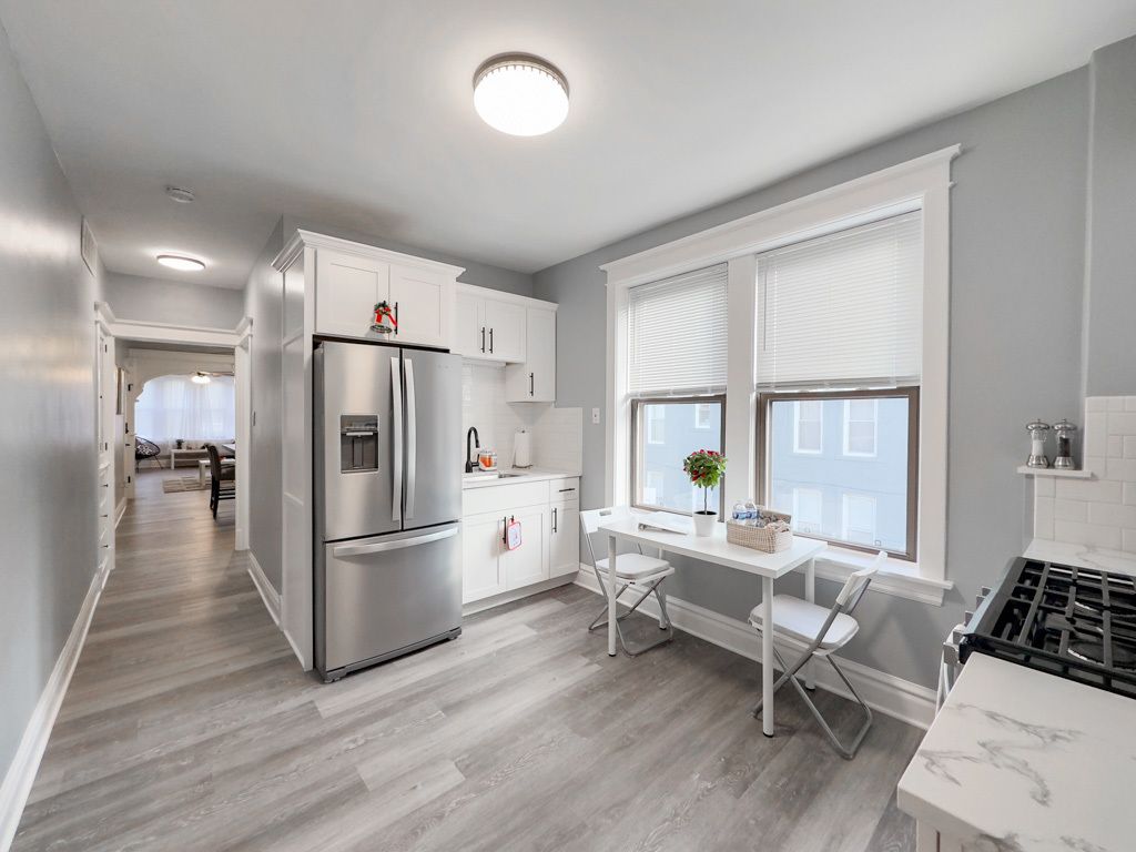 2039 West 23rd Street, Unit 2 Chicago, IL 60608 - Photo 6 of 21 a living room with furniture a large window wooden floor and a table