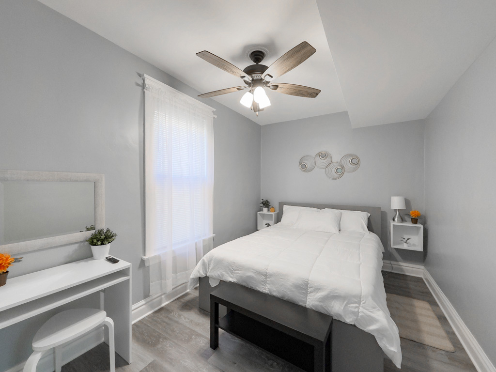 2039 West 23rd Street, Unit 2 Chicago, IL 60608 - Photo 7 of 21 a bedroom with a bed and a chandelier