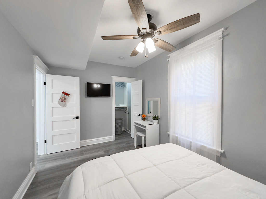 2039 West 23rd Street, Unit 2 Chicago, IL 60608 - Photo 8 of 21 a bedroom with a bed and a chandelier