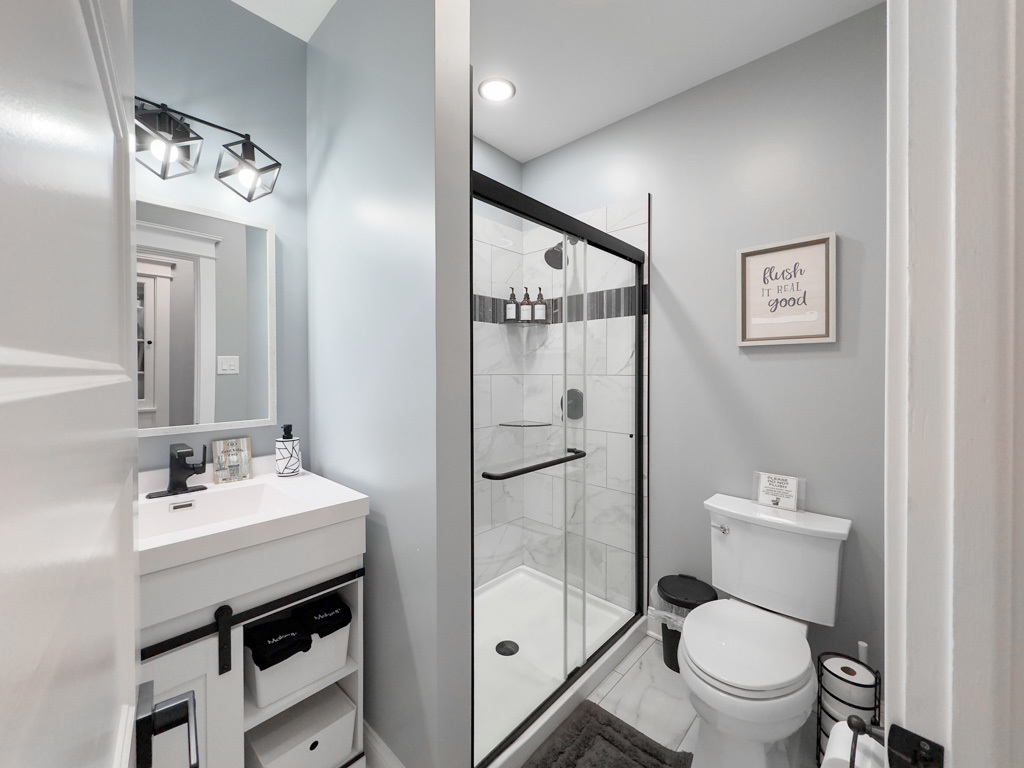 2039 West 23rd Street, Unit 2 Chicago, IL 60608 - Photo 9 of 21 a bathroom with a sink toilet and shower