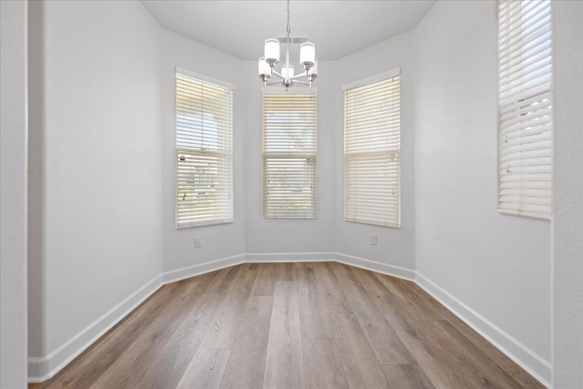 478 Churchill Way Salinas, CA 93906 - Photo 9 of 31 an empty room with wooden floor and windows