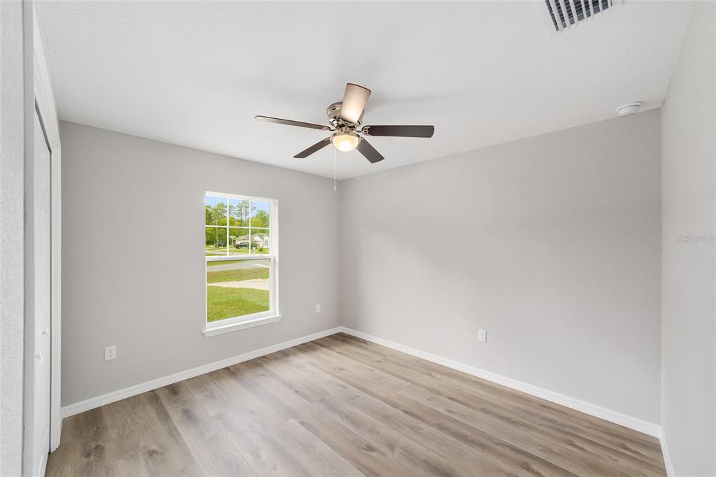 8767 North Quarry Way Dunnellon, FL 34434 - Photo 16 of 18 an empty room with a window and a ceiling fan