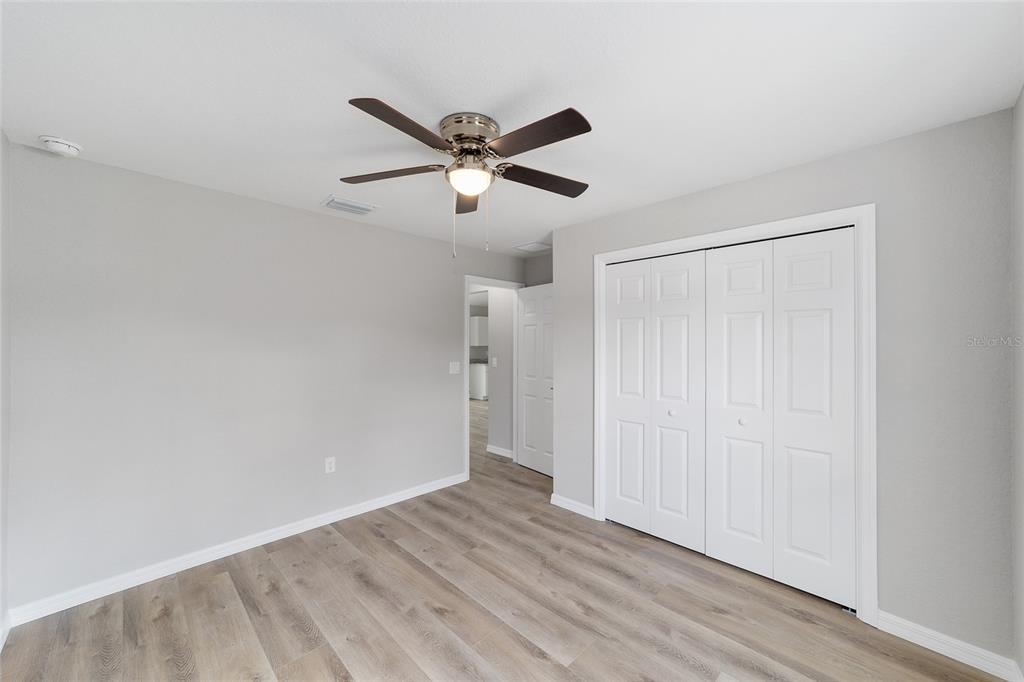 8767 North Quarry Way Dunnellon, FL 34434 - Photo 17 of 18 a view of empty room with wooden floor and ceiling fan