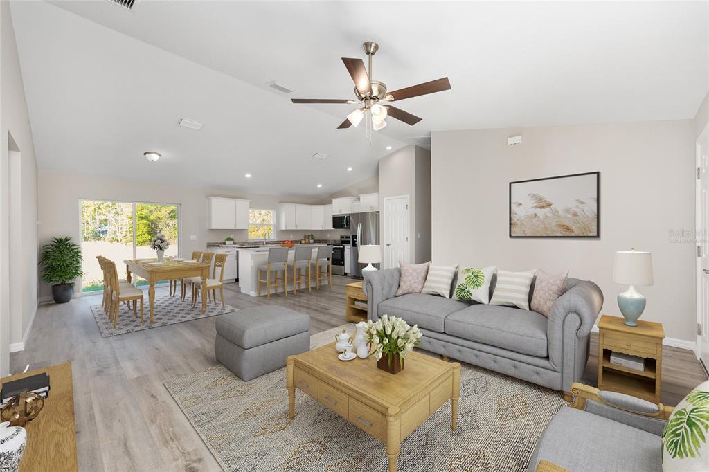 8767 North Quarry Way Dunnellon, FL 34434 - Photo 2 of 18 a living room with furniture kitchen view and a wooden floor