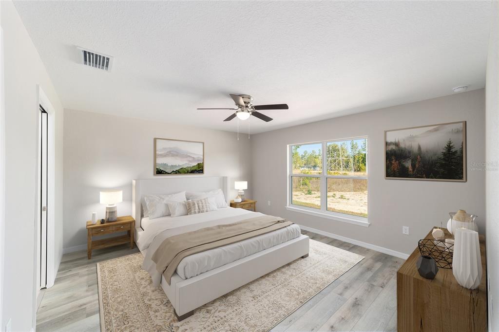 8767 North Quarry Way Dunnellon, FL 34434 - Photo 5 of 18 a bedroom with a large bed and a window