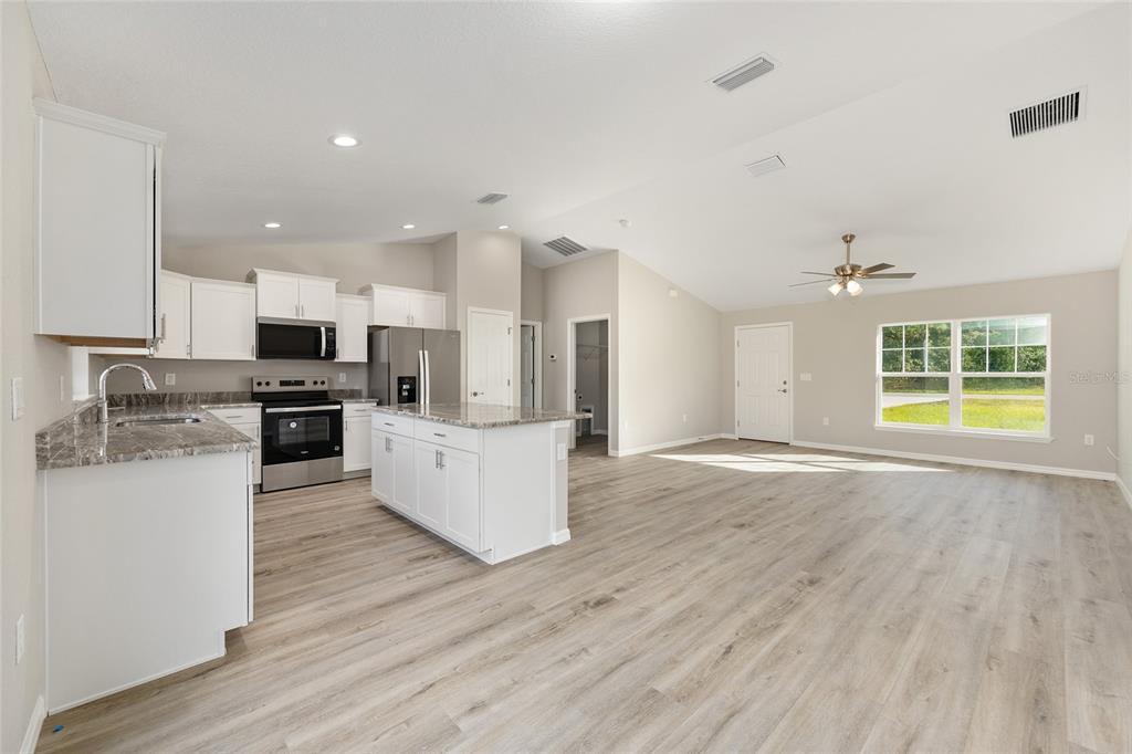 8767 North Quarry Way Dunnellon, FL 34434 - Photo 6 of 18 an open kitchen with kitchen island and stainless steel appliances