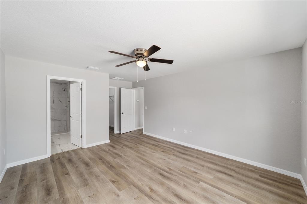 8767 North Quarry Way Dunnellon, FL 34434 - Photo 10 of 18 a view of empty room with wooden floor and ceiling fan