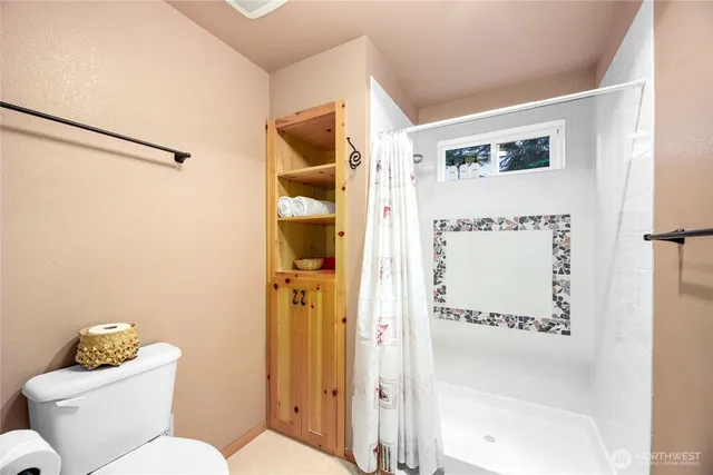 a white toilet sitting next to a bathroom sink