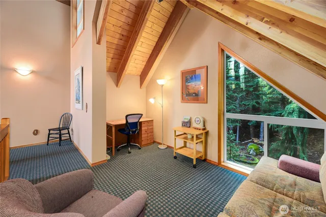 a balcony with furniture and a large window