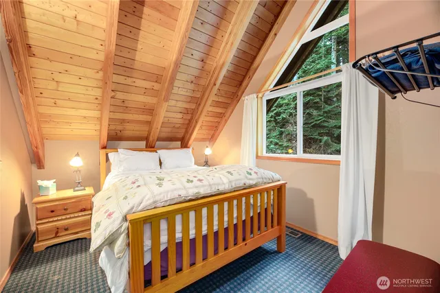 a bedroom with a bed next to a window