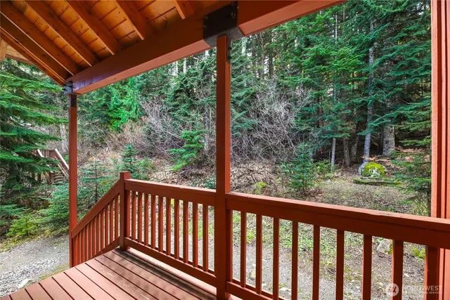 a view of a backyard with a large trees and wooden deck