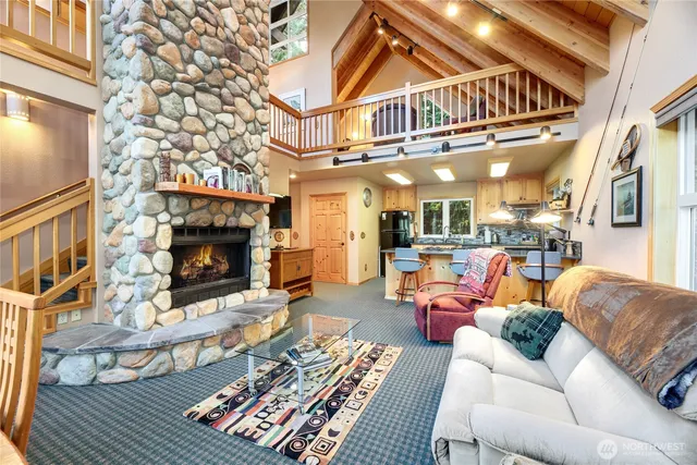 a living room with furniture a fireplace and a chandelier