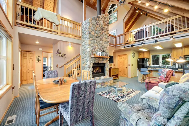 a living room with fireplace furniture and a chandelier