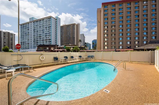 a view of a swimming pool with outdoor seating