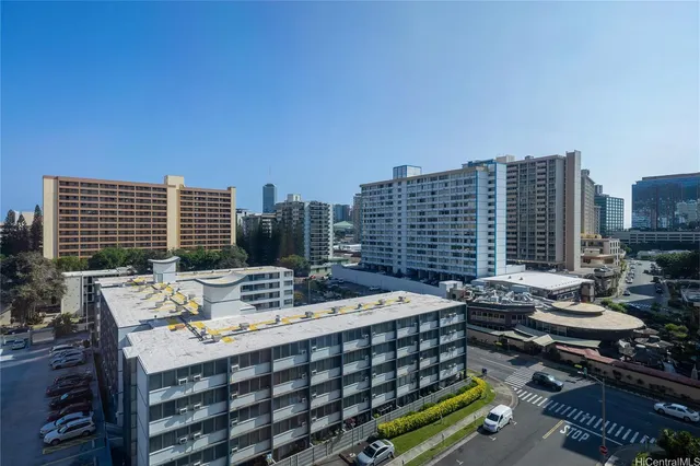 a view of a city with tall trees