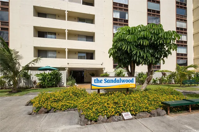 a front view of a multi story building with yard