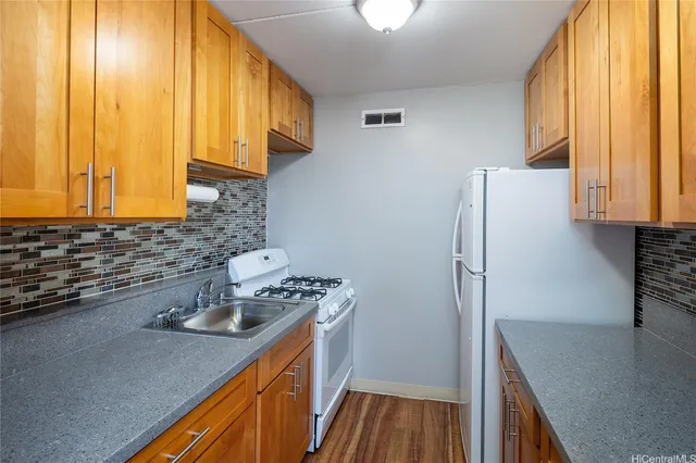 a kitchen with stainless steel appliances a sink a stove and a refrigerator