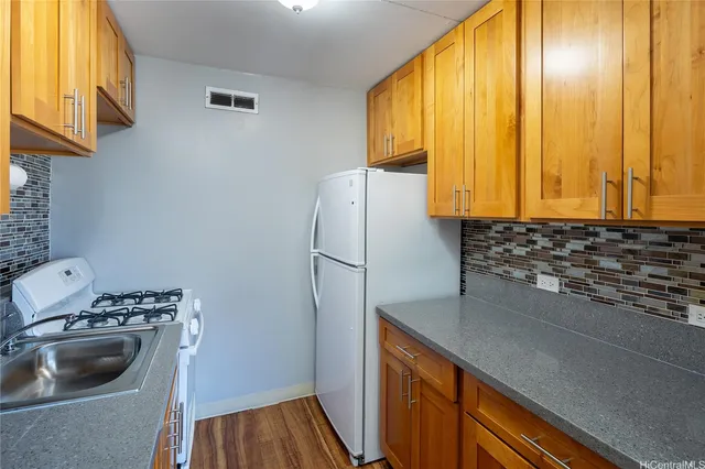 a kitchen with a refrigerator and a sink