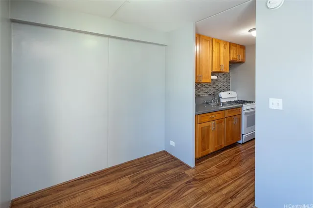 a view of a room that has wooden floor washer and dryer