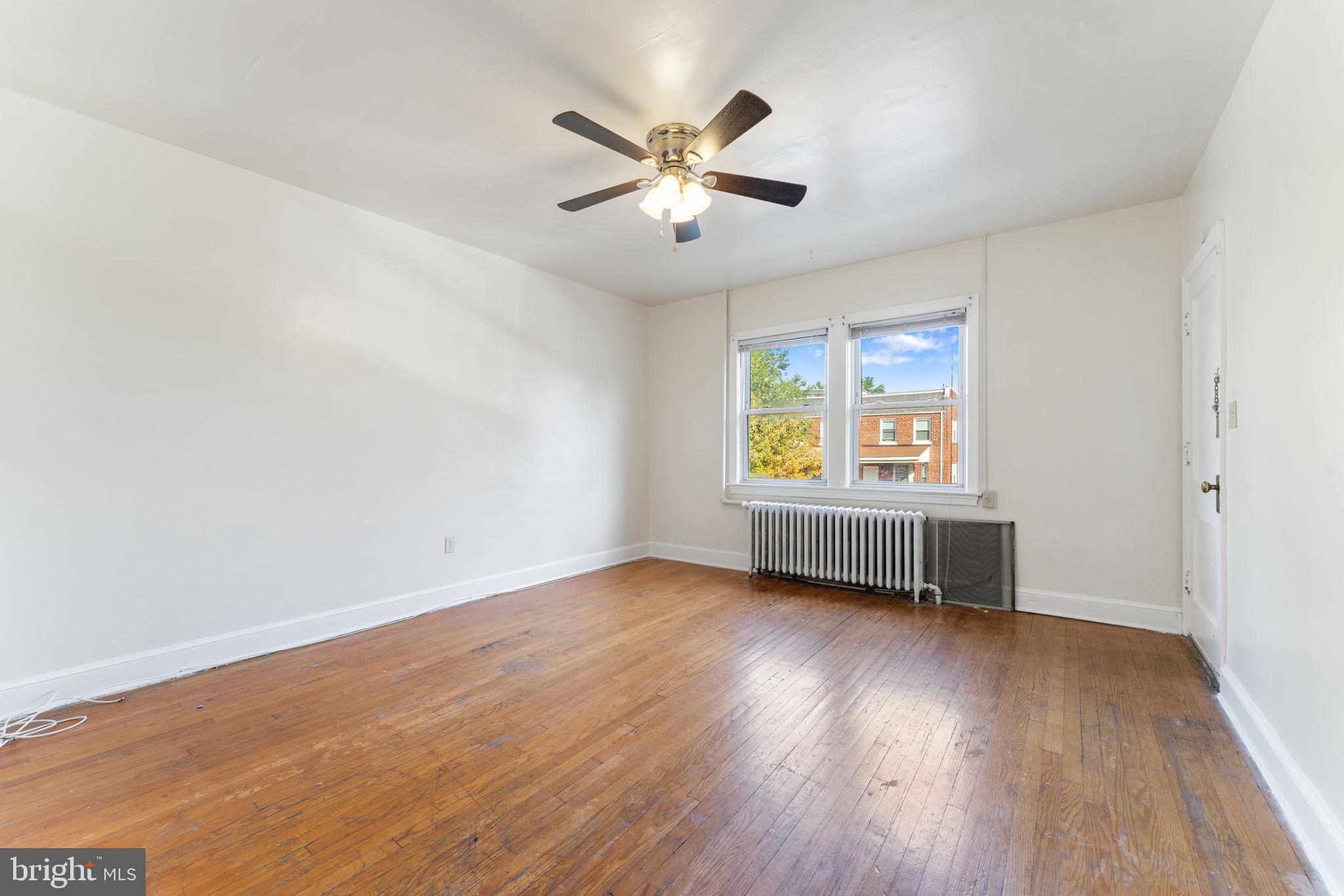 1408 Holbrook Street Northeast Washington, DC 20002 - Photo 13 of 20 an empty room with wooden floor ceiling fan and windows