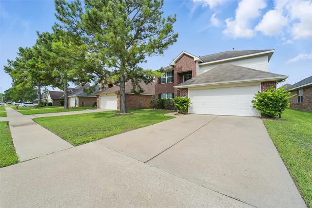 a front view of house with yard and green space