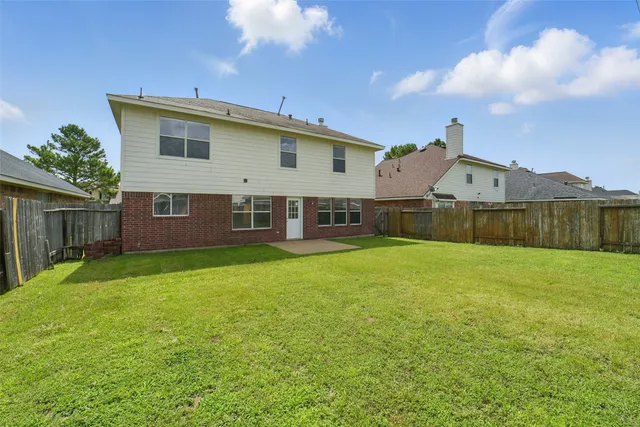 a view of a house with a backyard