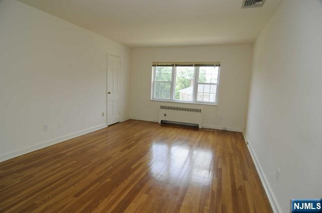 5 Heights Road, Unit G1 Ridgewood, NJ 07450 - Photo 3 of 7 an empty room with wooden floor and windows