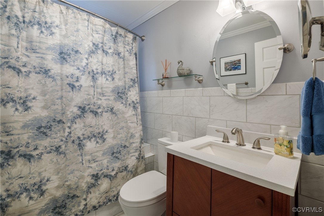 9603 River Road Henrico, VA 23229 - Photo 30 of 50 a bathroom with a sink a toilet and mirror