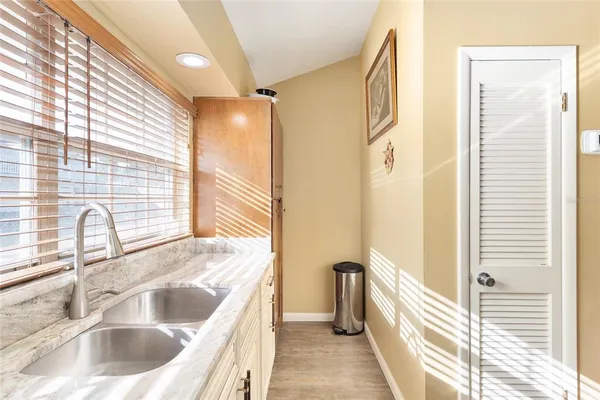 a kitchen with a sink and a large window