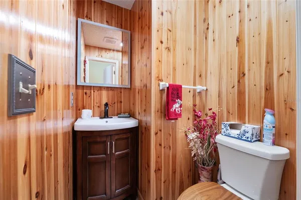 a bathroom with a sink toilet and a mirror
