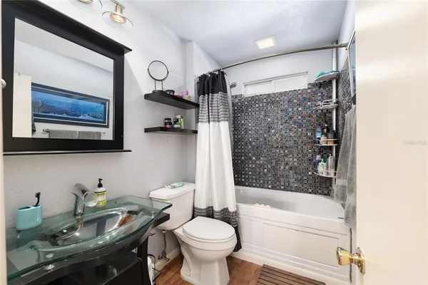 a bathroom with a sink toilet and shower