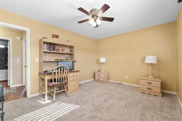 a bedroom with furniture and a lamp