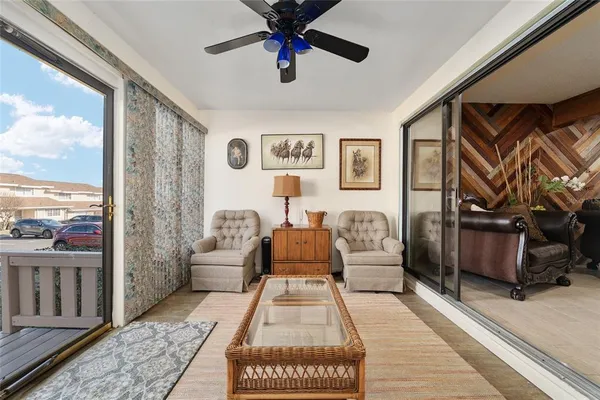 a living room with furniture and a floor to ceiling window