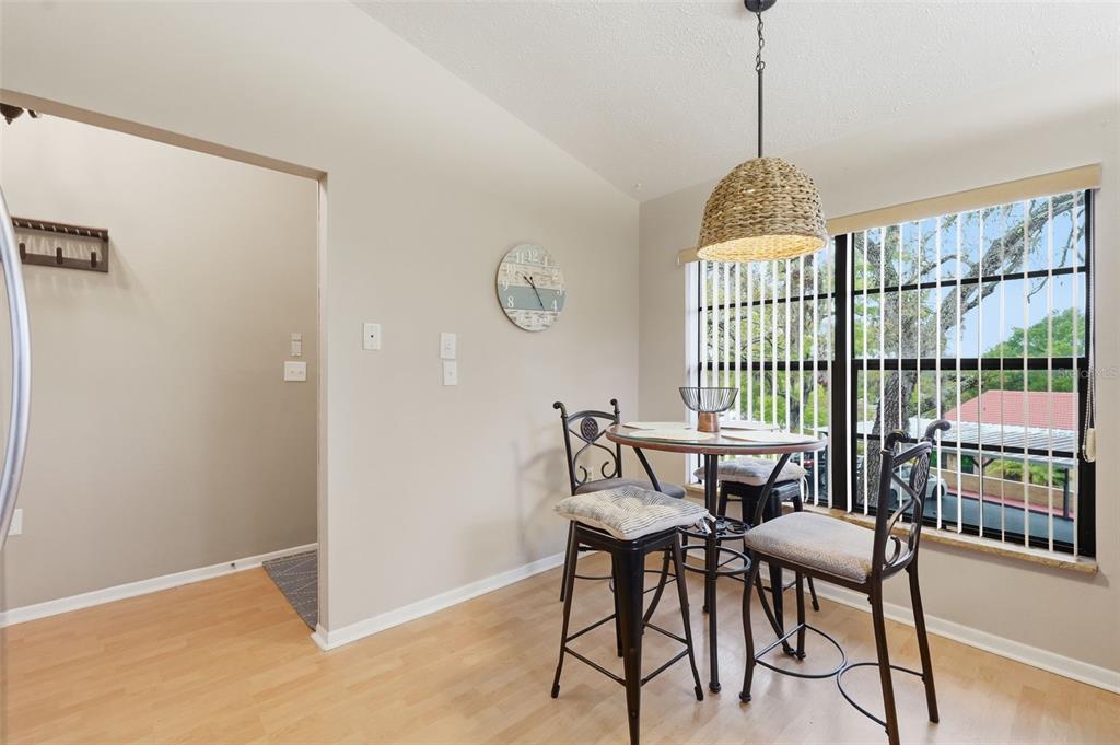 7650 Forest Trail, Unit 6 Port Richey, FL 34668 - Photo 11 of 37 a view of a dining room with furniture window and wooden floor