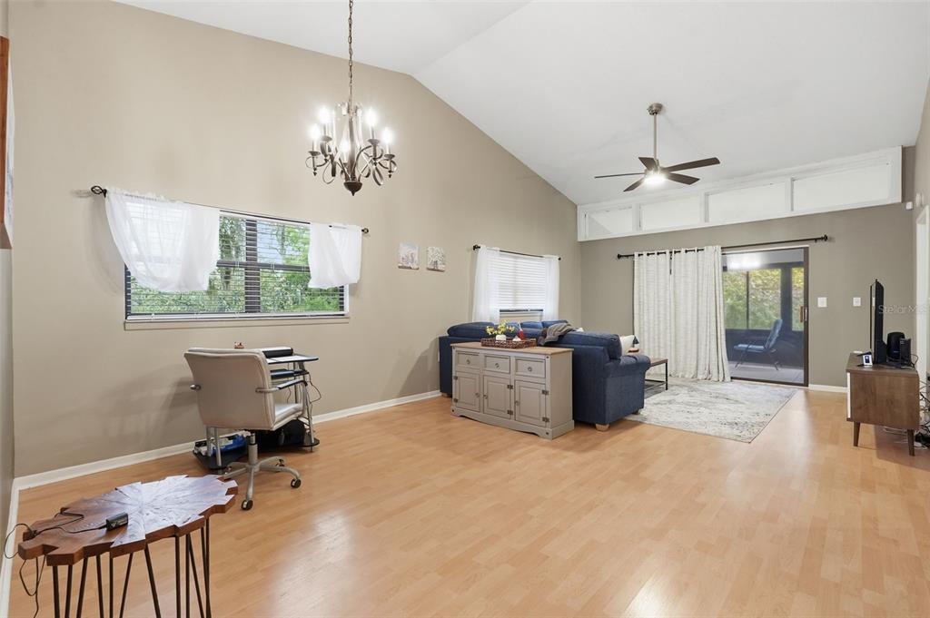 7650 Forest Trail, Unit 6 Port Richey, FL 34668 - Photo 13 of 37 a room with chandelier fan and windows