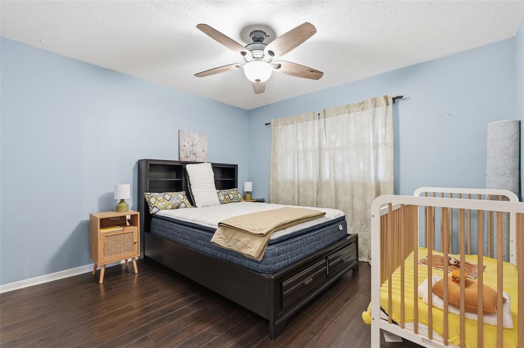 7650 Forest Trail, Unit 6 Port Richey, FL 34668 - Photo 23 of 37 a bed room with a bed and a tv