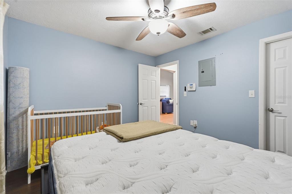 7650 Forest Trail, Unit 6 Port Richey, FL 34668 - Photo 24 of 37 a bedroom with a bed and a chandelier