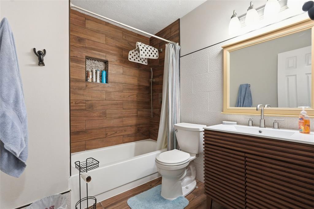 7650 Forest Trail, Unit 6 Port Richey, FL 34668 - Photo 25 of 37 a bathroom with a sink a toilet and shower