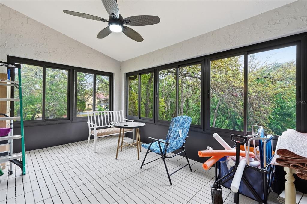 7650 Forest Trail, Unit 6 Port Richey, FL 34668 - Photo 28 of 37 a dining room with furniture a chandelier and wooden floor