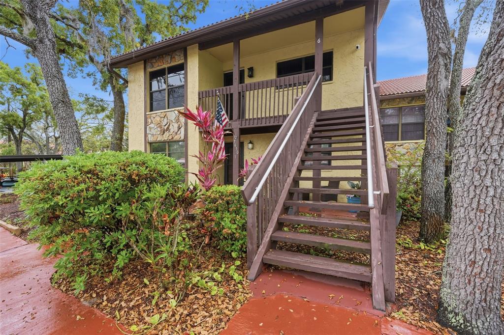 7650 Forest Trail, Unit 6 Port Richey, FL 34668 - Photo 30 of 37 a front view of a house with stairs